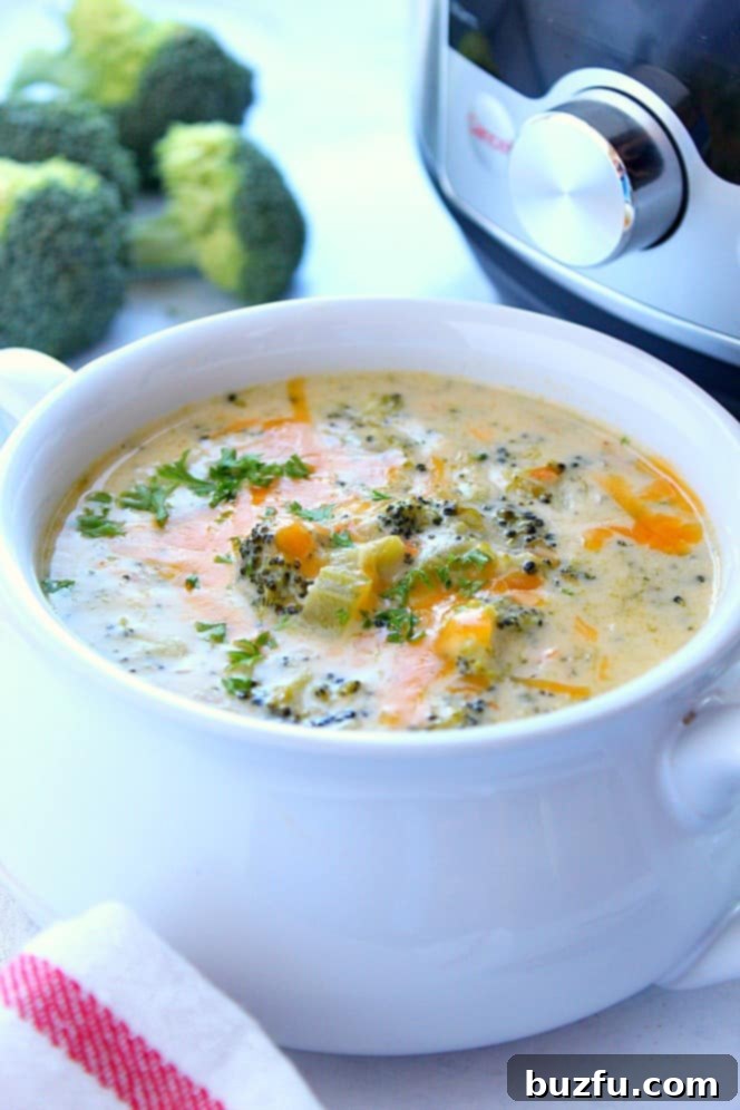 Instant Pot Broccoli Cheddar Soup Recipe - creamy and delicious veggie-packed soup with cheese. Popular restaurant copycat made right in your pressure cooker! Side shot of the broccoli cheddar soup right next to the Instant Pot, ready to serve.