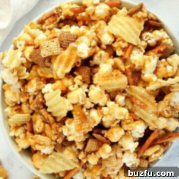Caramel popcorn mix with potato chips in a bowl, showcasing the rich caramel coating