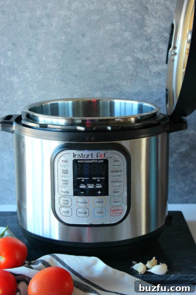 Instant Pot pressure cooker with lid open and resting on the side handle, showing the stainless steel inner pot.