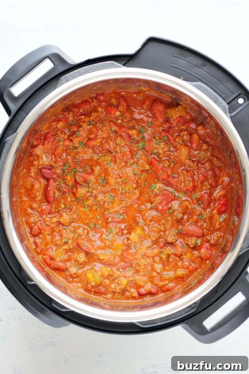 Instant Pot Chili in the pressure cooker. A bowl of rich, hearty chili in an Instant Pot insert.