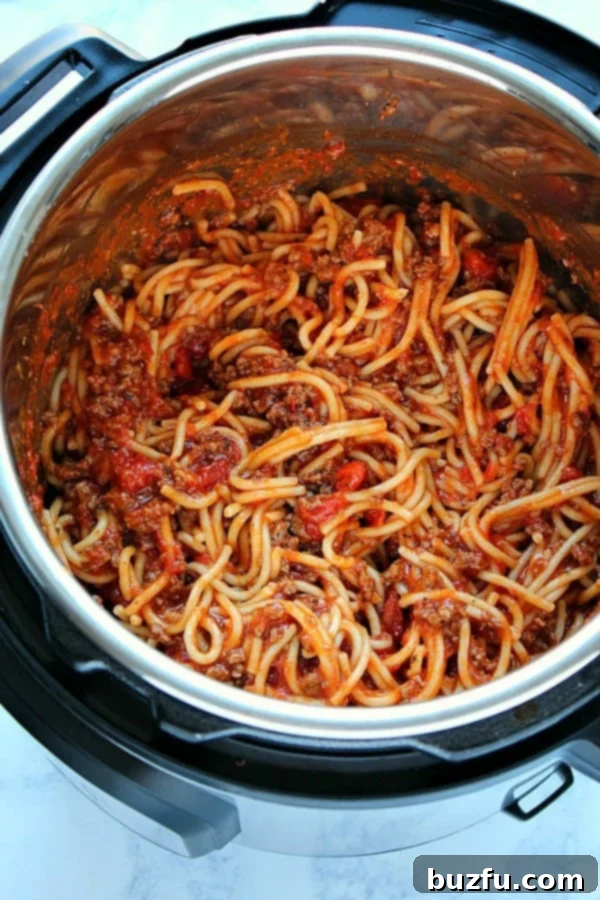 Instant Pot Spaghetti with Ground Beef - A Quick and Easy Family Dinner Spaghetti inside the pressure cooker, ready to be stirred.