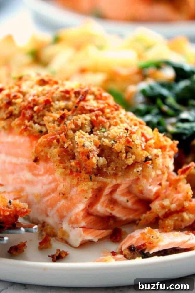 Parmesan Crusted Salmon on plate with potatoes and spinach.
