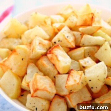 Golden Air Fryer Roasties 2 Roasted potatoes in a bowl, golden and ready to eat.