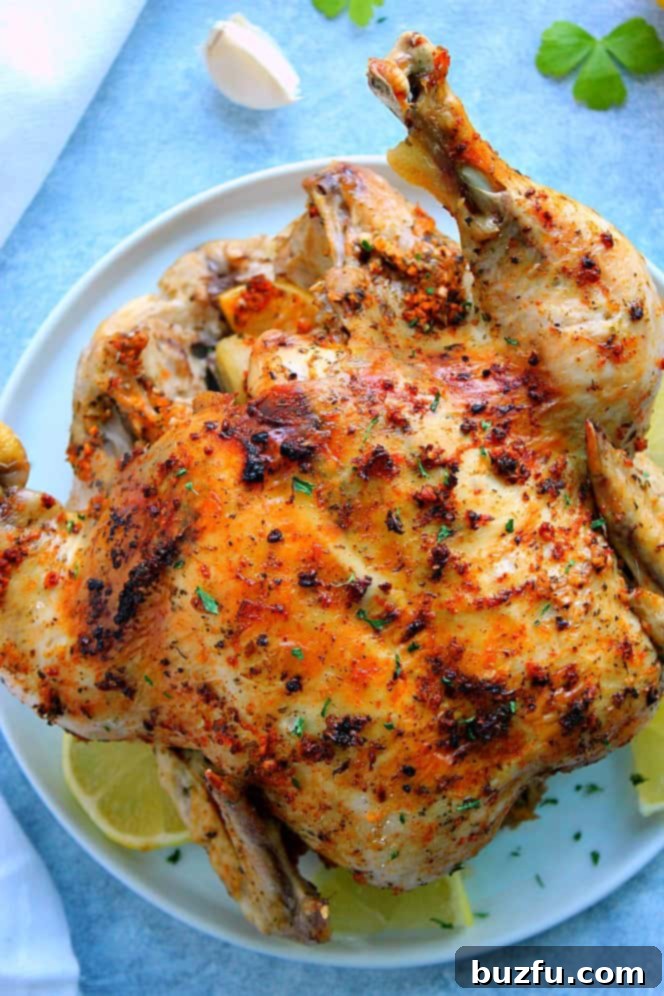 Instant Pot Whole Roasted Chicken on white plate.
