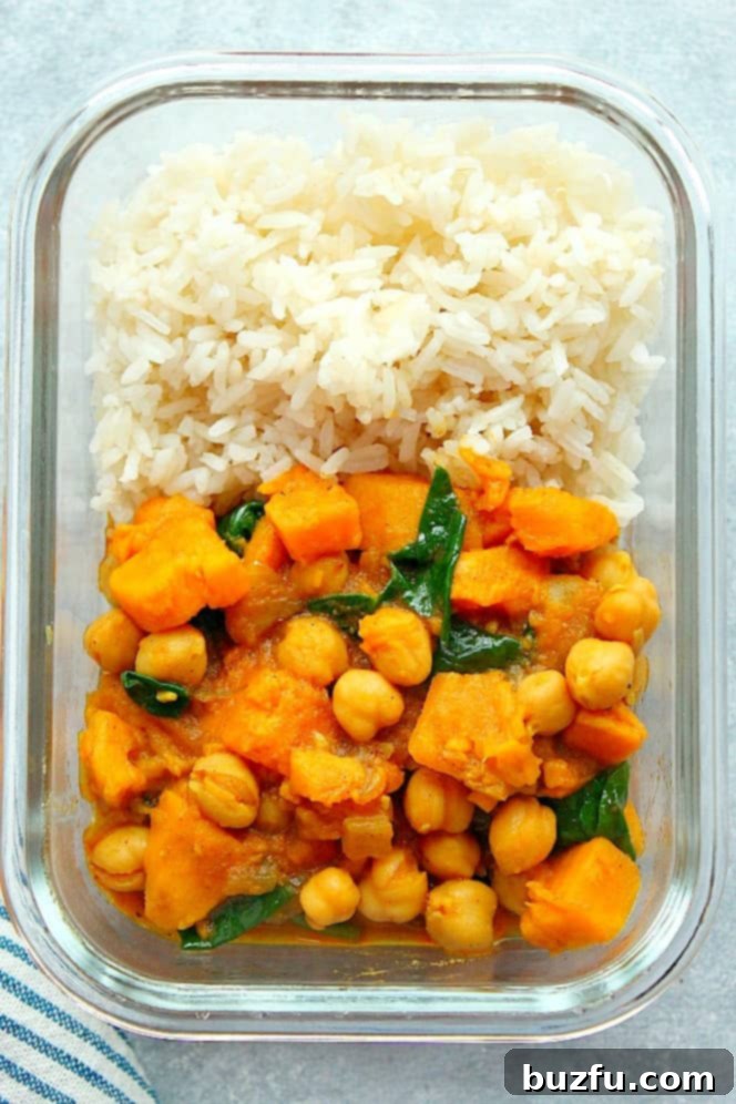 Instant Pot Sweet Potato Curry Recipe (Meal Prep) - easy vegetarian curry made with chickpeas, sweet potatoes and spinach. Perfect with rice for a simple meal prep throughout the week! Overhead shot of rice and Instant Pot sweet potato curry in glass meal prep bowl.
