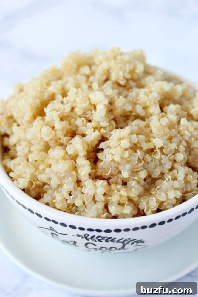 A close-up side shot of perfectly cooked quinoa in a bowl, showcasing its fluffy texture and readiness for any meal.