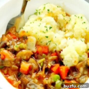 Delicious Vegetarian Shepherd's Pie in a bowl with a spoon, ready to be enjoyed.