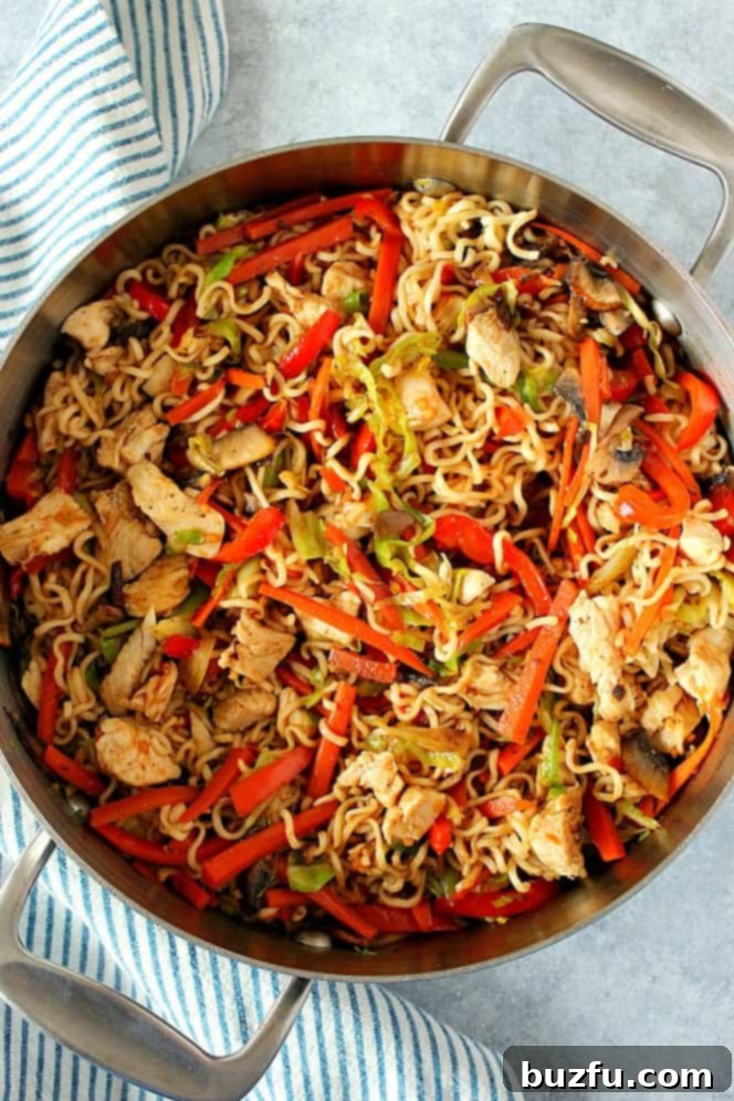 Delicious chicken yakisoba served in a vibrant, steaming saucepan, showcasing its rich noodles, tender chicken, and colorful vegetables.