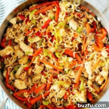 Chicken Yakisoba with vegetables in a skillet.
