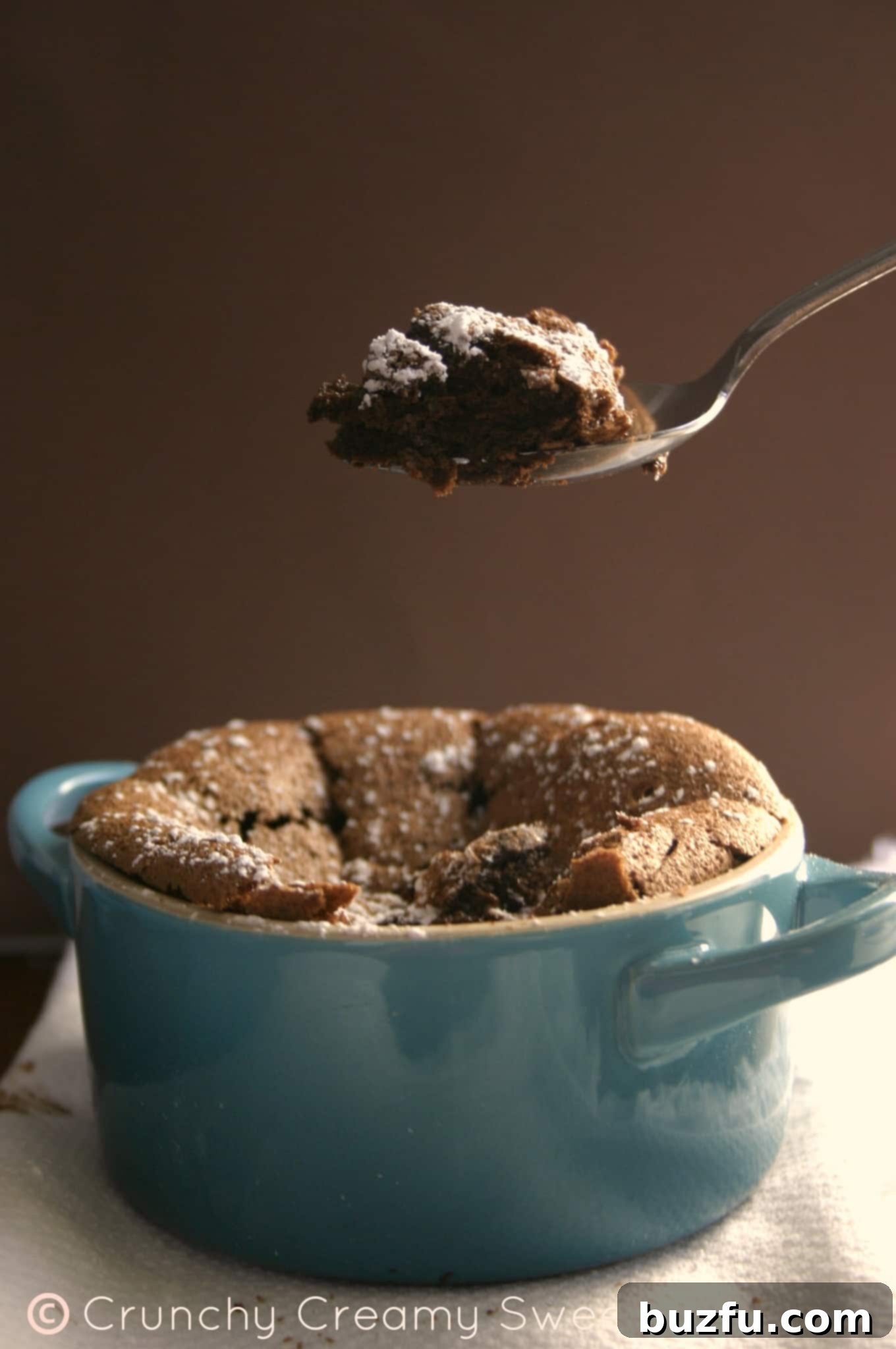 Creamy Chocolate Souffle A close-up of a perfectly baked chocolate souffle, showing its creamy texture inside
