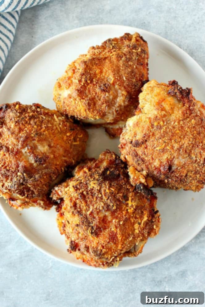 This Air Fryer Fried Chicken is juicy inside and crispy on the outside. Four air fried chicken thighs on white plate.