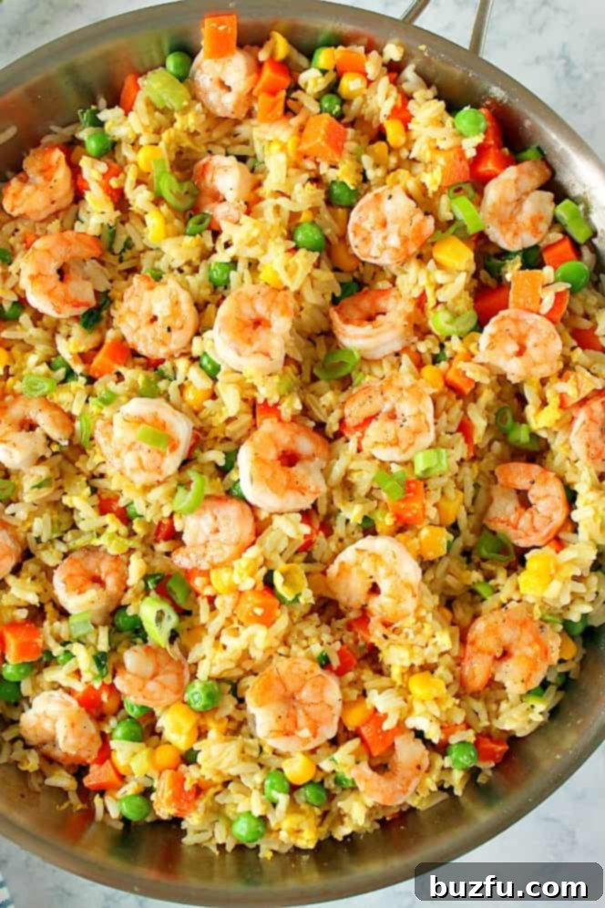 Shrimp Fried Rice in a stainless steel skillet, ready to be served. Overhead shot.