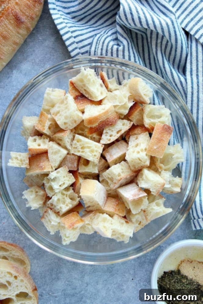 Overhead shot of cubed baguette in glass bowl.