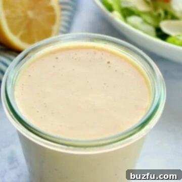Creamy Caesar Dressing in a medium glass jar, ready to use.