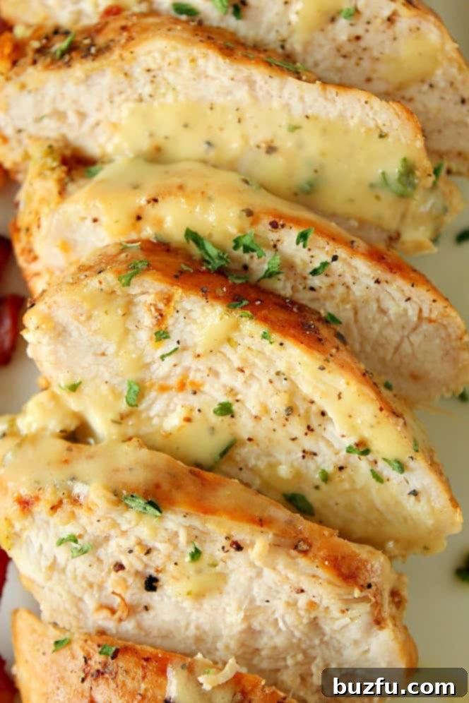 How to make lemon garlic chicken in skillet for Cobb salad. Close up shot of perfectly sliced lemon garlic chicken breast, highlighting its tender texture and golden crust.