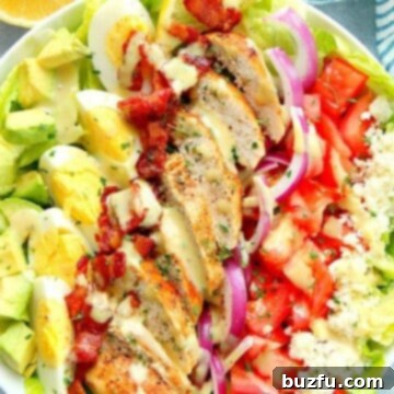 The Ultimate Chicken Cobb Salad 2 Chicken Cobb Salad on large salad bowl.
