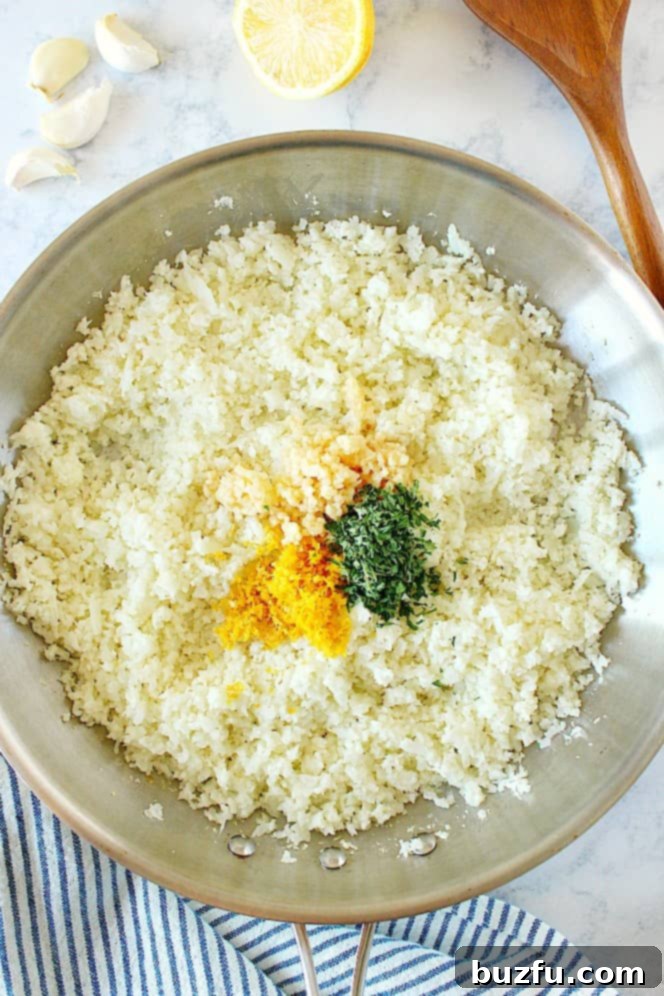 How to make garlic cauliflower rice. Overhead shot of cauliflower rice, lemon zest, garlic and parsley in pan.