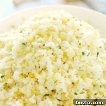 Zesty Lemon Garlic Cauliflower Rice 2 Cauliflower rice with lemon in a bowl.