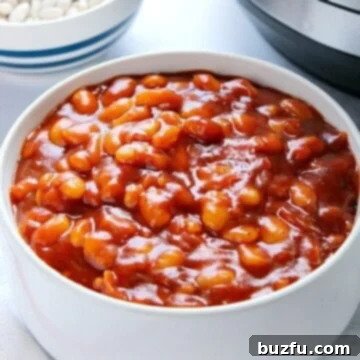 Baked beans in white bowl, next to Instant Pot.