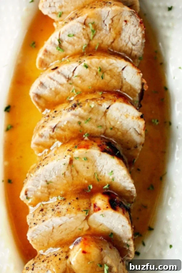 Delicious Instant Pot Pork Tenderloin with Honey Garlic Gravy Overhead shot of sliced pork tenderloin with gravy, ready to serve.