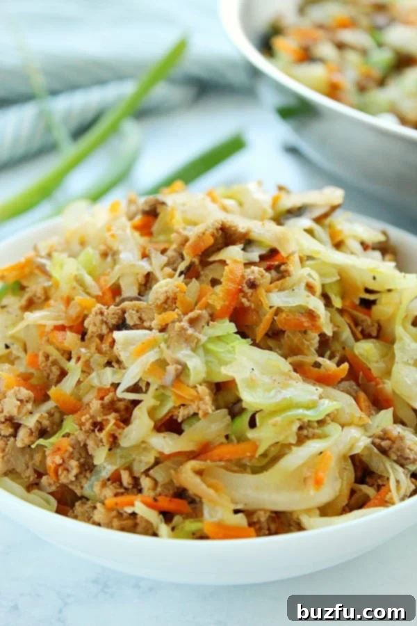 A vibrant Egg Roll in a Bowl, showcasing a delicious mix of ground meat and colorful vegetables in a white bowl.