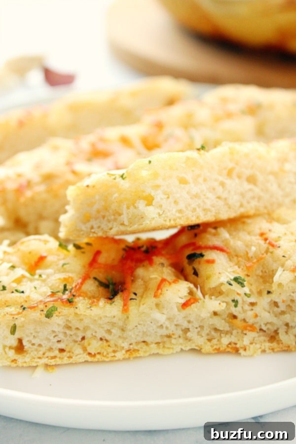 How to make easy homemade Focaccia in a skillet in just one hour. Slices of focaccia on white plate.