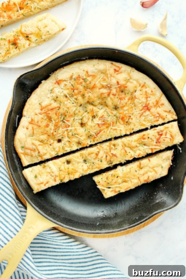 One-Hour Skillet Focaccia - the best recipe for focaccia! Easy yeast bread that's baked in a skillet and takes only 1 hour to make! Check out our tips on making a perfect focaccia every time! Skillet Focaccia in cast iron skillet sliced into pieces.