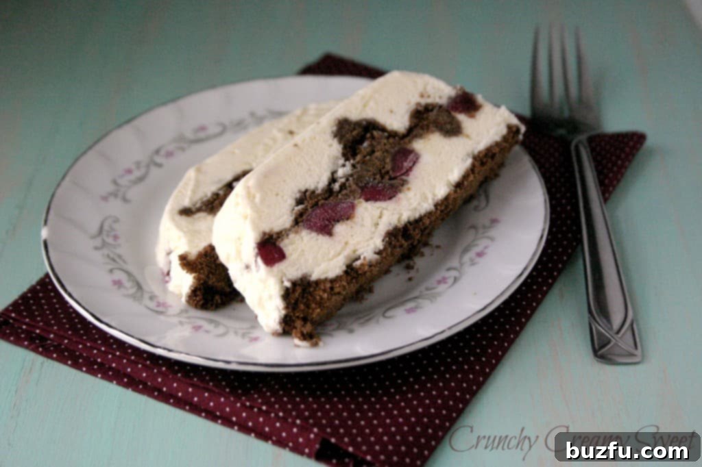 Luxurious Black Forest Semifreddo 3 A top-down view of the Black Forest Semifreddo, showcasing its intricate layers before being sliced, topped generously with a homemade cherry sauce.