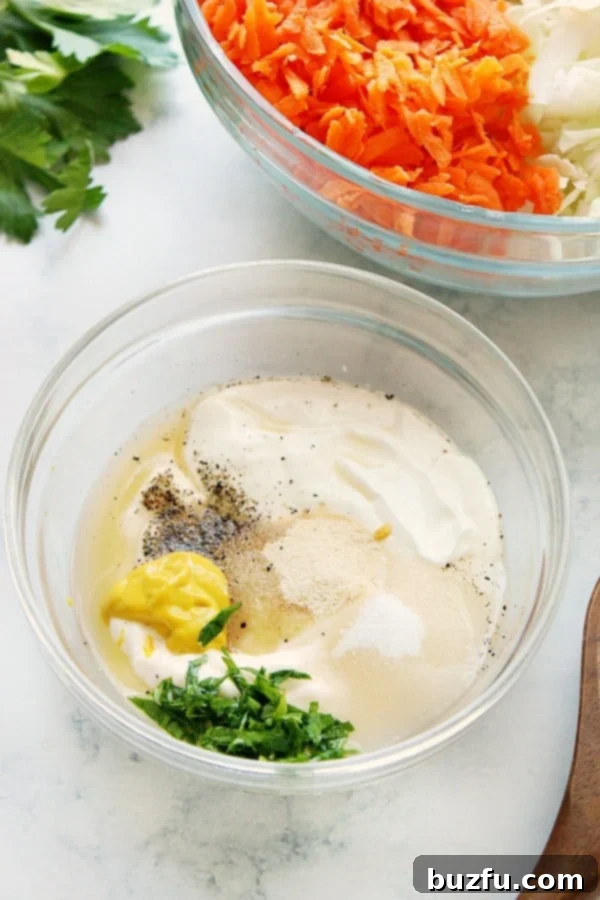 Ingredients for creamy coleslaw dressing in a small glass bowl, whisked to perfection.