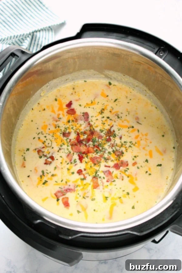 Instant Pot Potato soup with melted cheddar and crispy bacon, served directly from the pressure cooker.