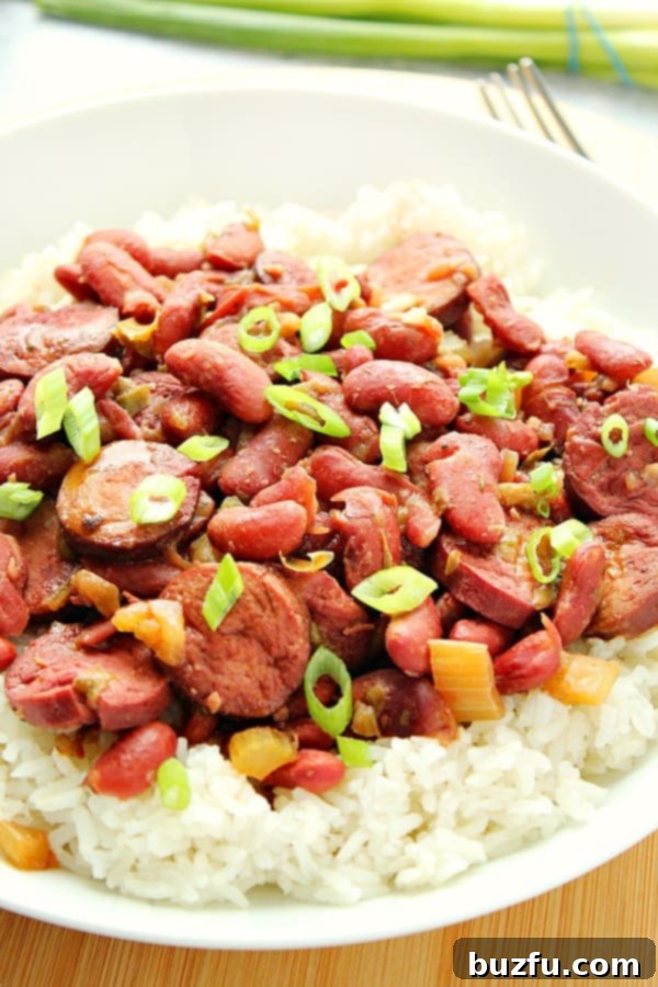 Instant Pot Red Beans and Rice on a white plate, garnished with green onions.