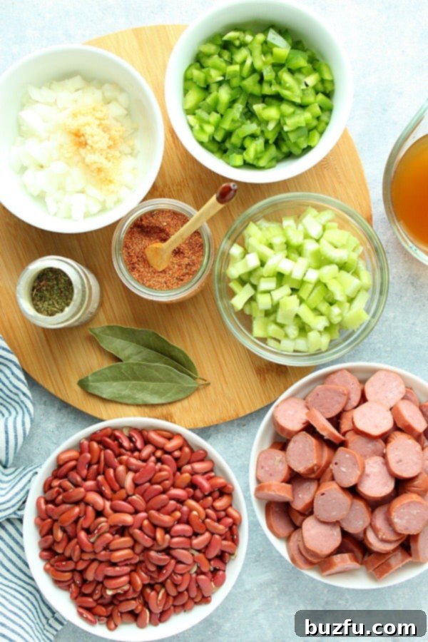 Ingredients for Instant Pot Red Beans and Rice laid out on a wooden board.