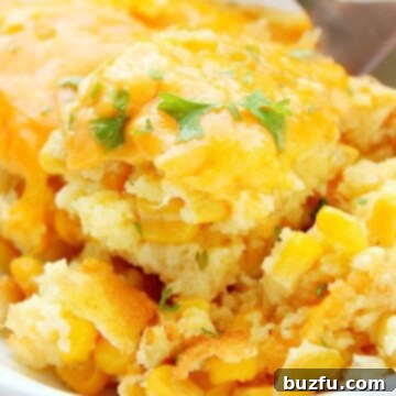 Creamy Sweet Corn Bake 6 Sweet Corn Casserole in a serving bowl with fork.