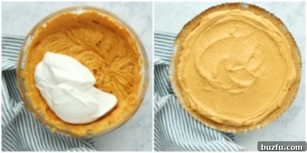 Stiff peaks of whipped cream being gently folded into the pumpkin mixture with a spatula.