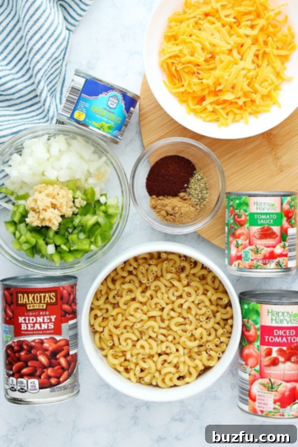 All the fresh and canned ingredients for Instant Pot Chili Mac laid out on a marble board.