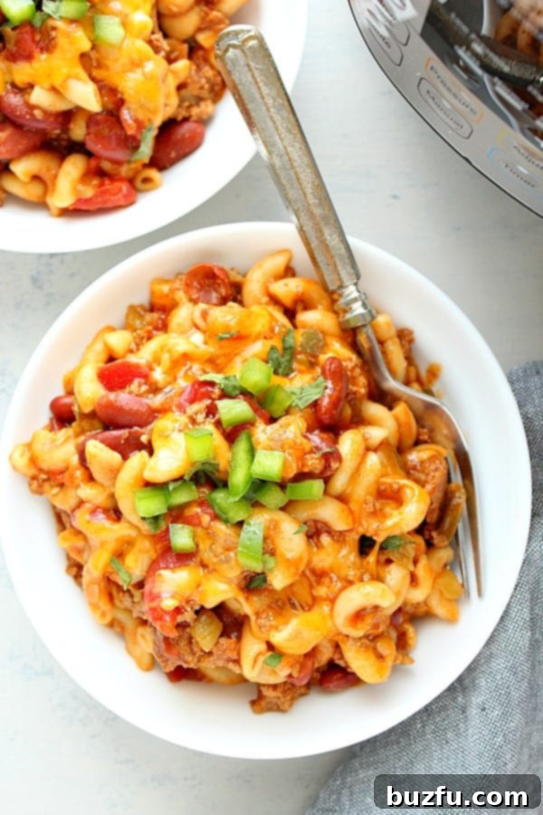 Overhead shot of Instant Pot Chili Mac and Cheese served in white bowls, garnished.