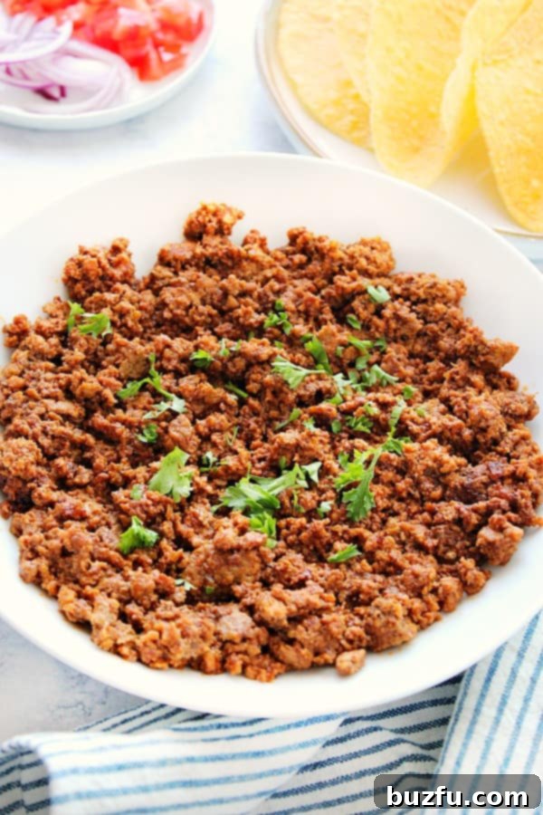 Instant Pot Taco Meat in a white bowl, garnished and ready to serve.