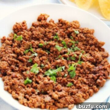 Instant Pot Taco Meat in a white bowl, garnished and ready to serve.