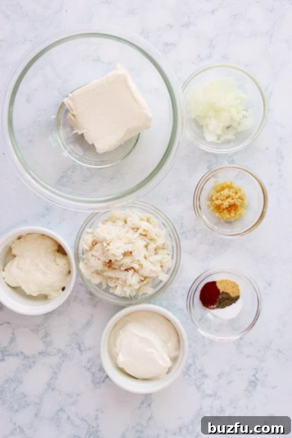 Hot Crab Dip ingredients on a marble board, arranged nicely.