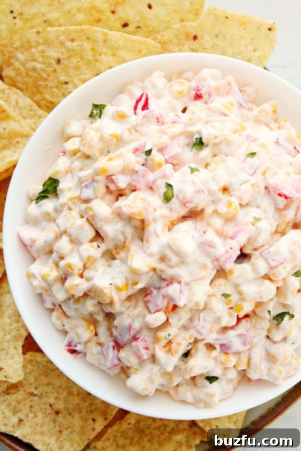 The perfect Creamy Corn Dip for any party or get-together. A beautifully presented bowl of Creamy Corn Dip, ready to be served.