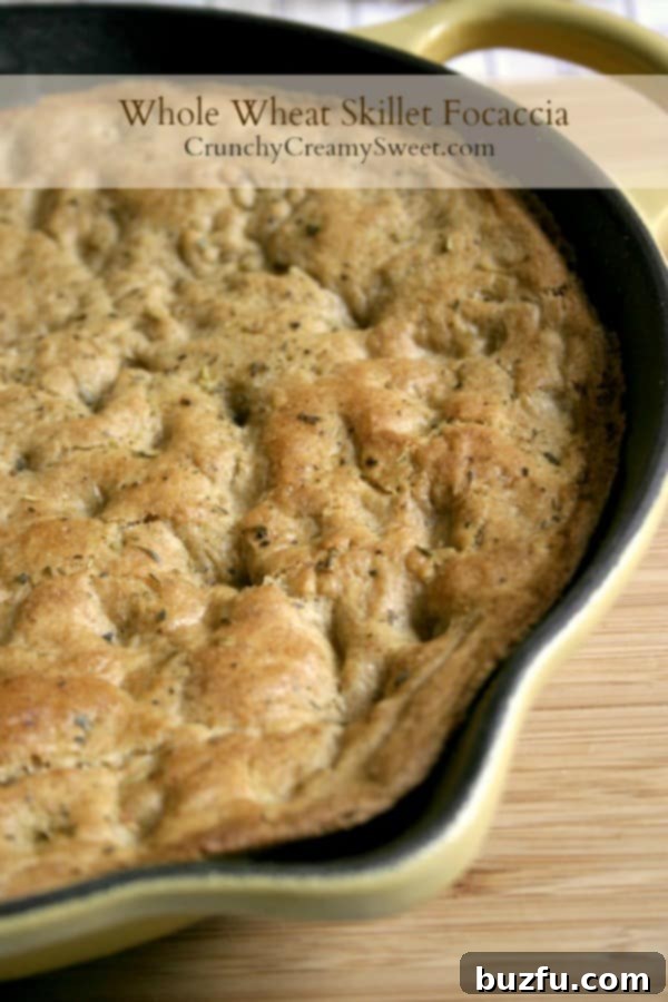 Whole Wheat Focaccia in a skillet, freshly baked and golden brown.