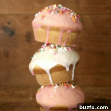 Vanilla Bean Glazed Donut Muffins 2 A close-up of a perfectly baked and glazed vanilla donut muffin with colorful sprinkles, showing its tender crumb.
