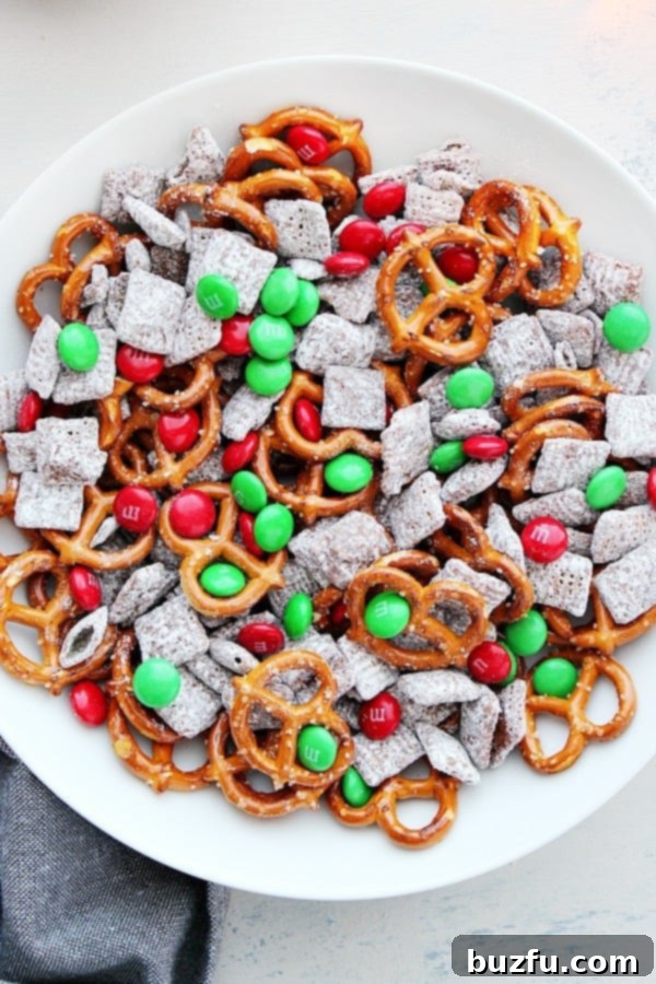 Reindeer Chow in a white bowl, a festive Christmas snack mix.