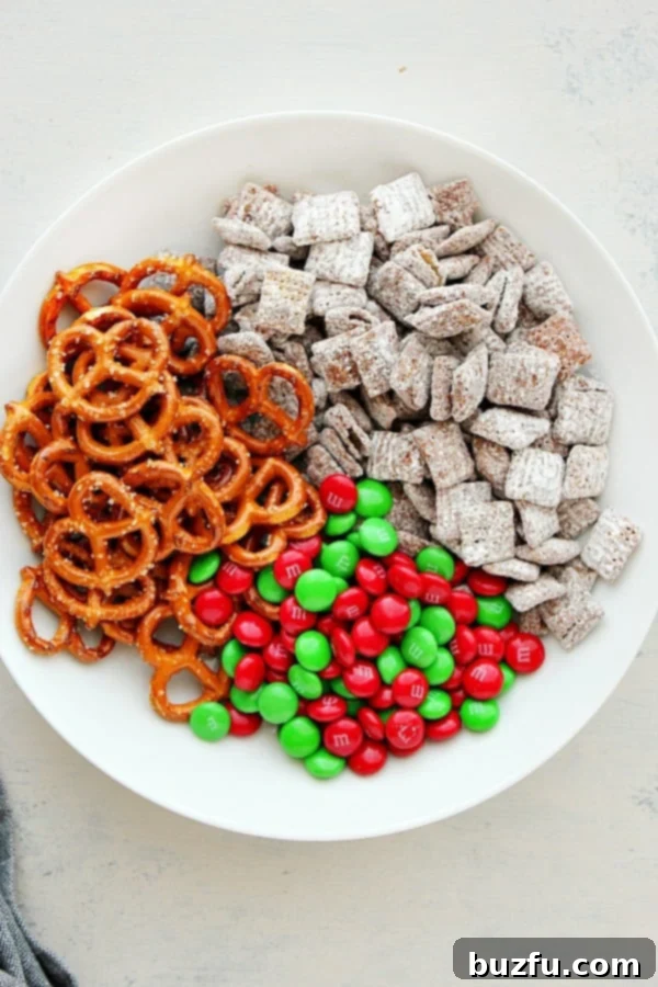 Ingredients for Reindeer Chow in a white bowl, ready for mixing.