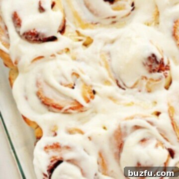 Foolproof Cinnamon Rolls 3 Freshly baked cinnamon rolls in a glass baking dish, generously covered with cream cheese frosting.
