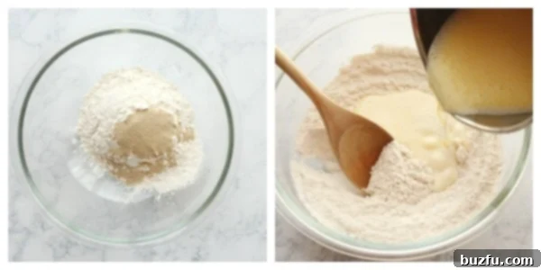 Whisk dry ingredients with warm milk mixture. A large mixing bowl with flour and yeast being whisked together.