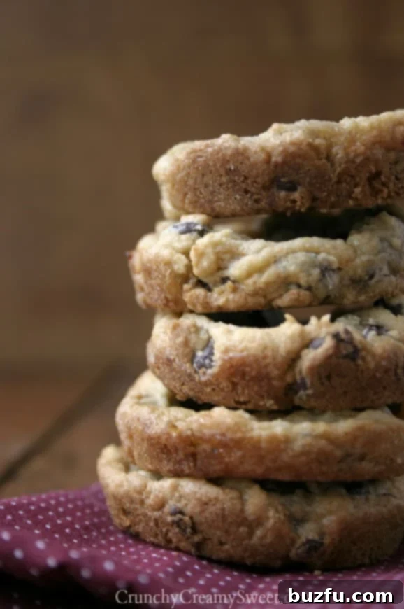 Close-up of freshly baked chocolate chip pudding cookie cups in a muffin pan, ready to be filled