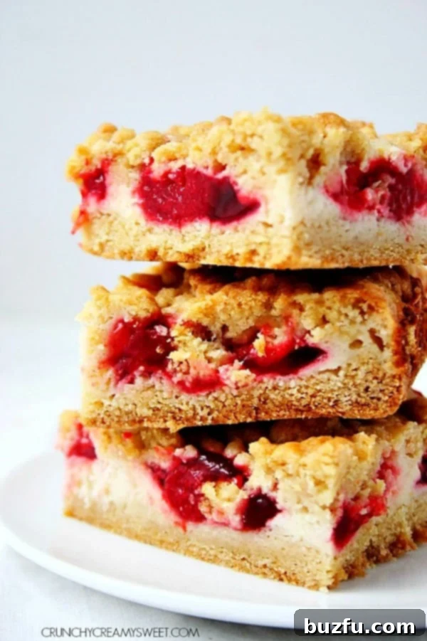 Strawberry Pie Crumb Bars stacked up on white plate.