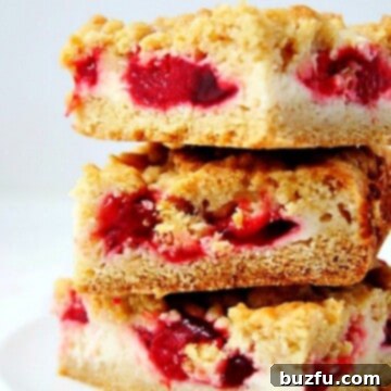 Strawberry Pie Crumb Bars stacked up on white plate.