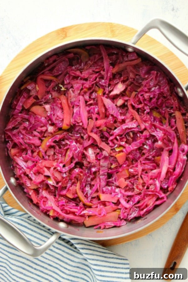 Braised red cabbage simmering in a deep skillet.